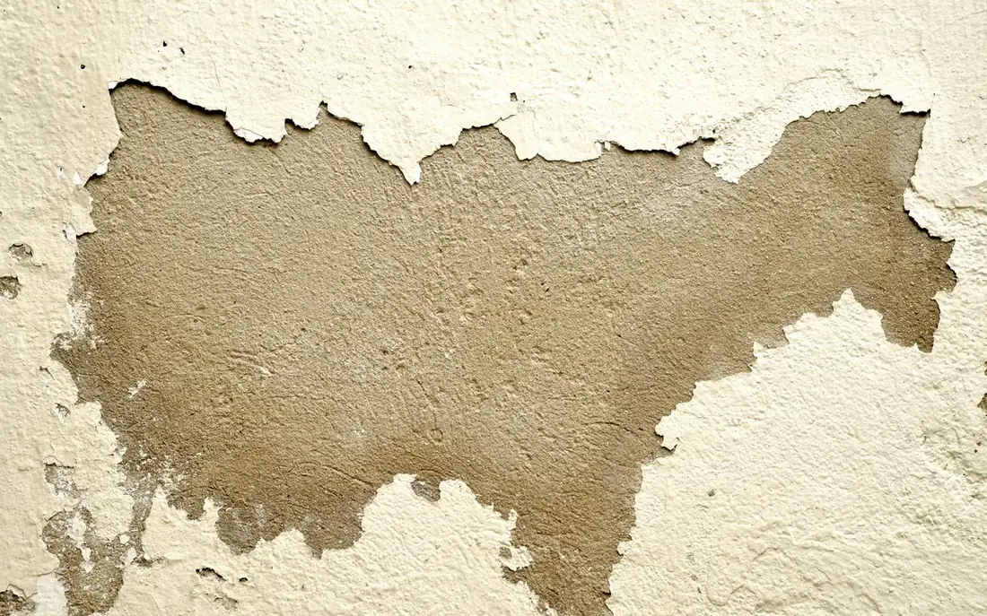 Paint peeling from a wall after water damage in a Casa Grande, AZ home
